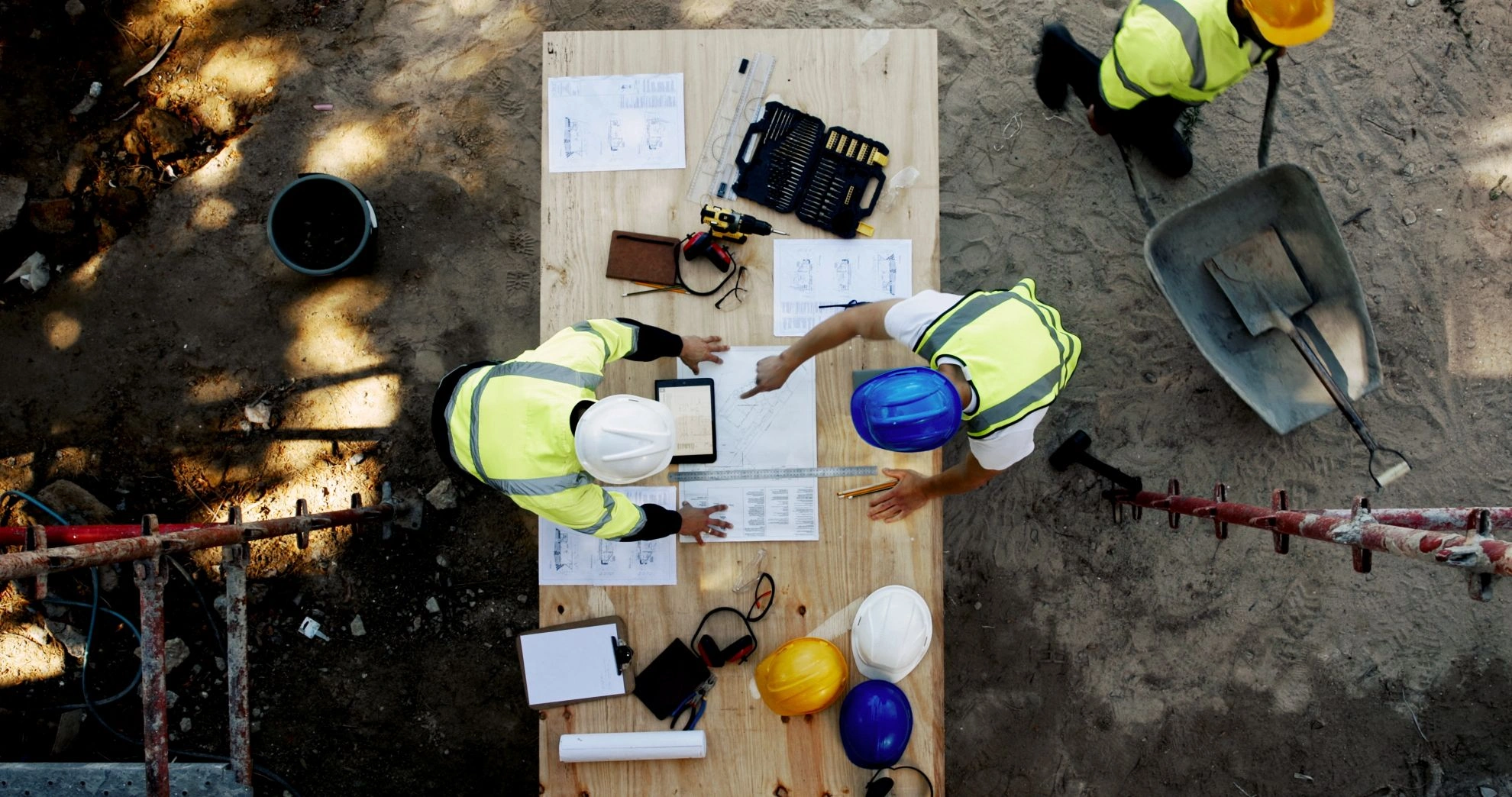construction-workers-reviewing-plans-at-a-job-site-2026-03-25-03-31-04-utc